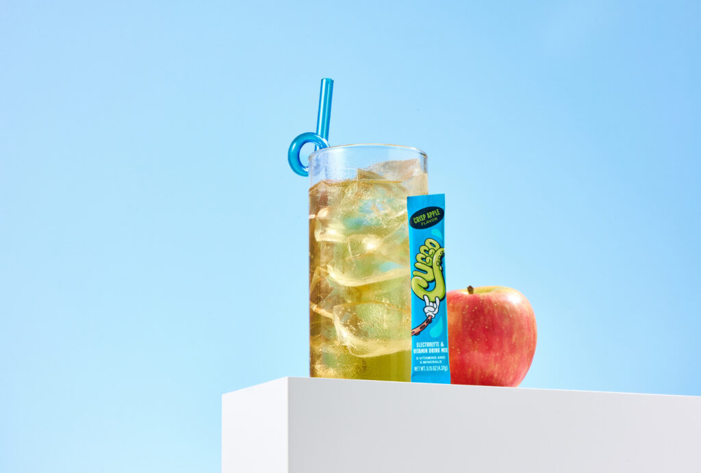Flavor-forward product photography featuring CUGGO, a crisp-apple hydration drink for kids. 