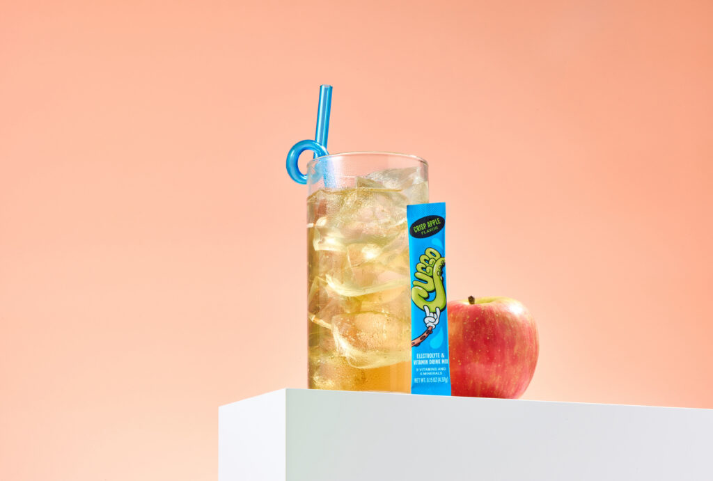 Flavor-forward product photography featuring CUGGO, a crisp-apple hydration drink for kids. 