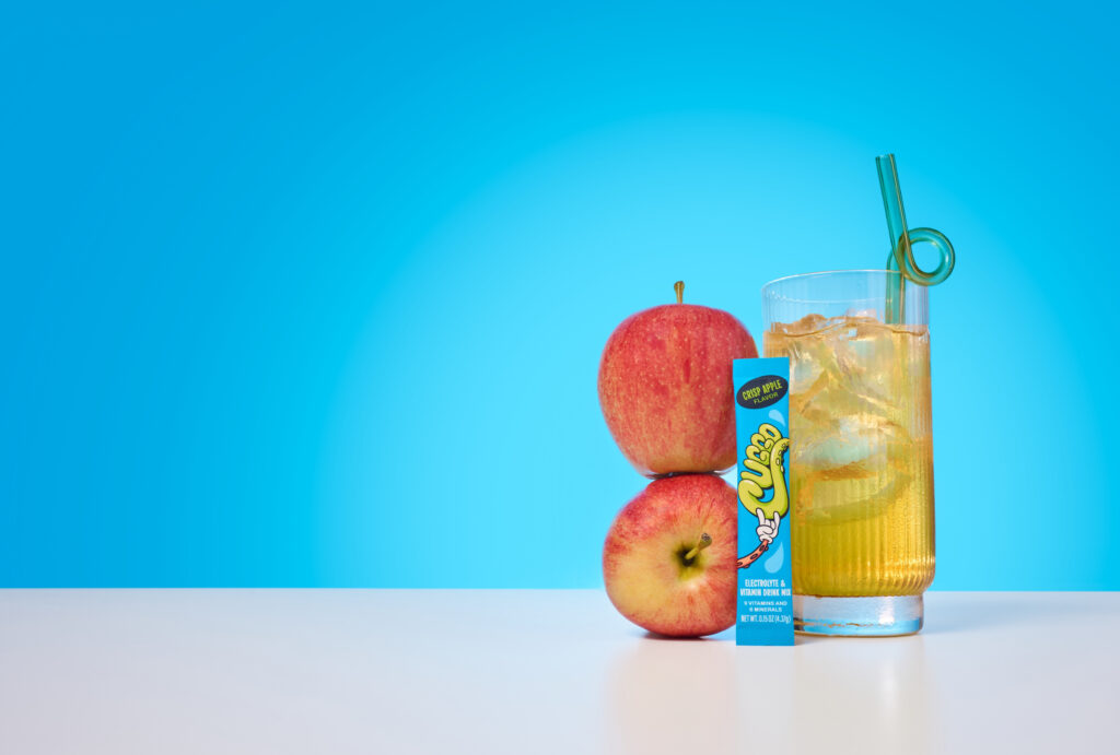 Flavor-forward product photography featuring CUGGO, a crisp-apple hydration drink for kids. 