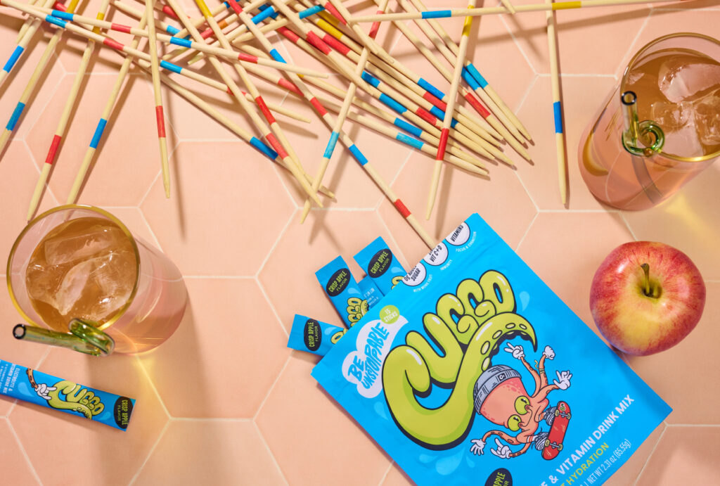 Flavor-forward product photography featuring CUGGO, a crisp-apple hydration drink for kids. 