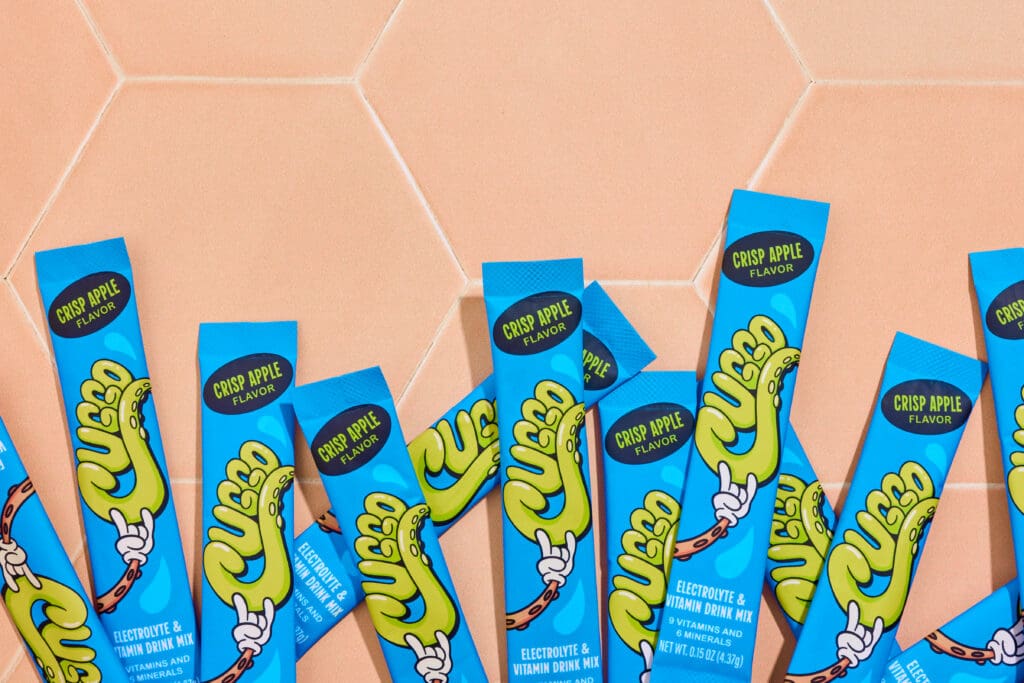 a flat lay, photography shot of Cuggo drink mix, crisp apple flavor. 