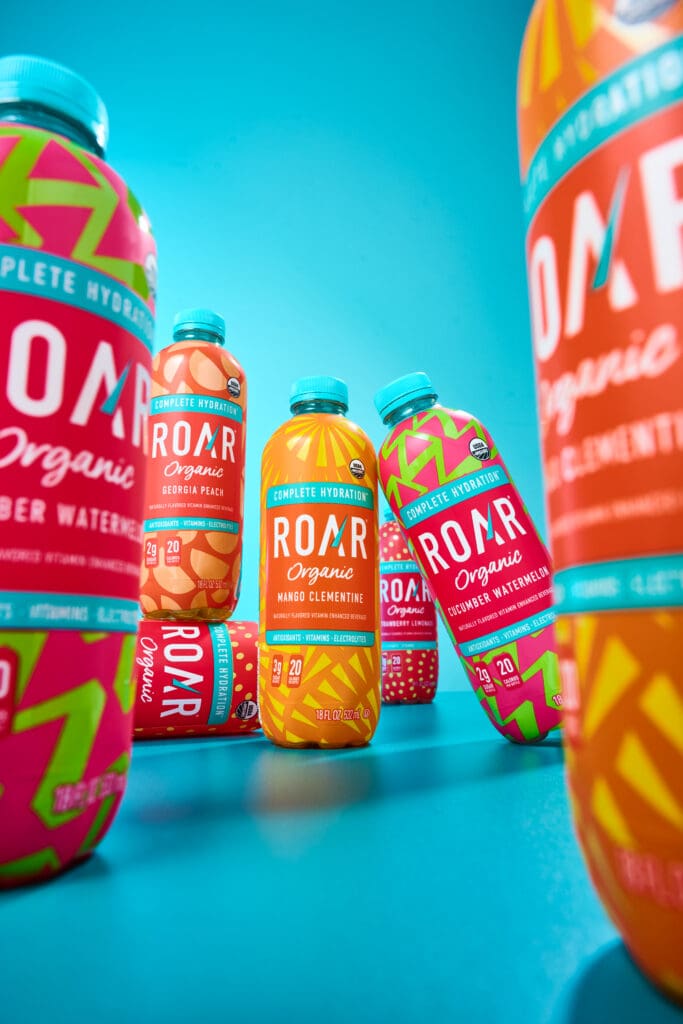 A diptych of Roar Organic product shots featuring mangos and their bottles.